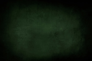 dark green grunge background or texture with black vignette borders