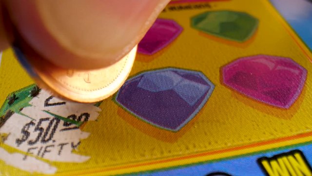Macro close-up of an instant lottery scratch card.