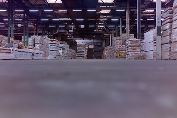 Timber Flooring Factory. Pile of cut wood in factory storage warehouse. Lumber in warehouse.