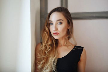 Close-up portrait of young attractive woman in black sportwear