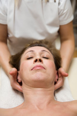 Fototapeta na wymiar Closeup face of a woman having facial massage at spa