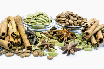 Coffee and cardamom grains, anise and cinnamon isolated on a white background.