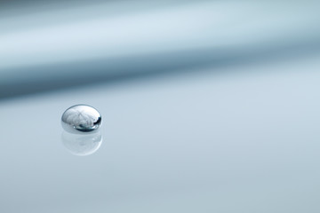 Shiny Mercury drops over a glass surface