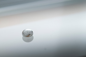 Shiny Mercury drops over a glass surface