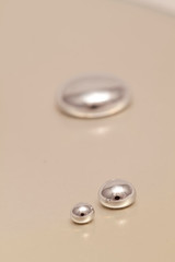 Shiny Mercury drops on a white background