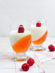 Delicious italian dessert panna cotta with berry jelly on wooden background, food concept
