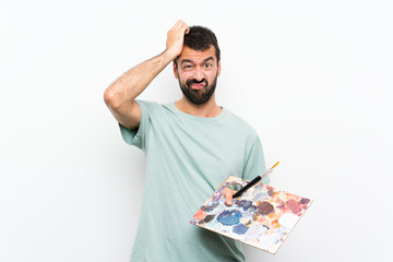 Young artist man holding a palette over isolated background with an expression of frustration and not understanding