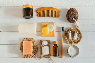 Zero waste bathroom accessories on blue background. Flat lay bamboo toothbrushes, wooden hair comb,...