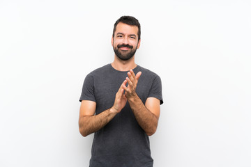 Young handsome man over isolated white background applauding after presentation in a conference