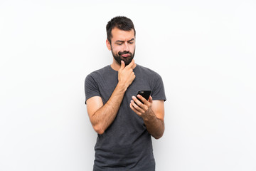 Young handsome man over isolated white background thinking and sending a message