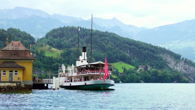 Swiss Flag. Traditional steamboat ship on Lake Lucerne, Swiss Alps.  Luzern beautiful Alpine nature. Switzerland summer luxury tourism, 4k. 