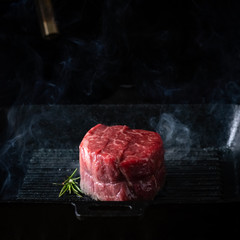 Filet Mignon steak in a pan, the process of cooking on the grill