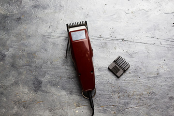 machine for a hairstyle. Barbershop. Hair clippers isolated on blue background. The machine for a...