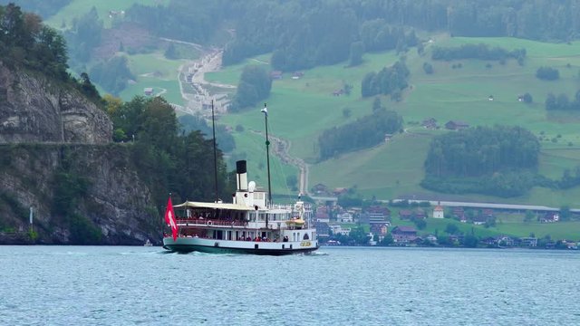 Traditional steamboat ship on Lake Lucerne, Swiss Alps. Swiss Flag. Luzern beautiful Alpine nature. Switzerland summer tourism destination, 4k. 