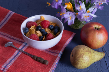 snowdrops, pear, apple and granola are on the table