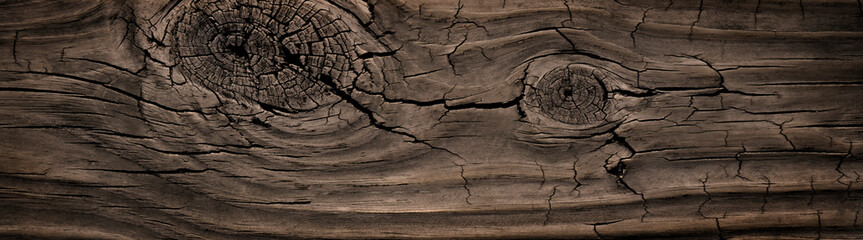 Rough splintered neutral reclaimed wood surface with aged boards lined up. Wooden planks on a wall or floor with grain and texture. Dark vintage wood planks background.