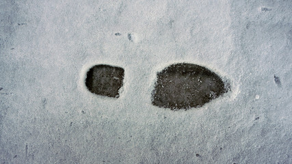 human footprints on snow in winter, shoe prints on snow,