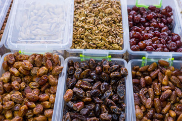 store counter with dried fruits. In plastic containers, the fruits of dried dates. Healthy food. natural nutrition. Vegetarian Products