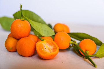 Calamondins on white cutting board