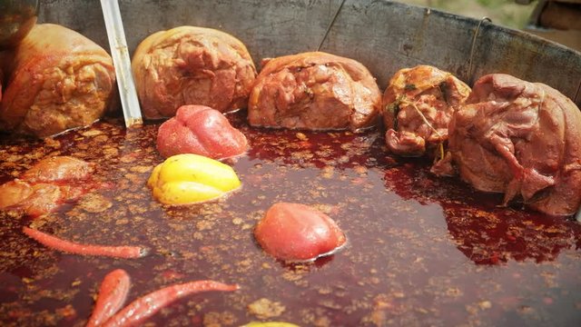 Bograch. Soup with paprika, meat, bean, vegetable, dumpling. Traditional Hungarian Goulash in cauldron. Meal cooked outdoors on an open fire. HD