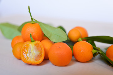 Calamondins on white cutting board