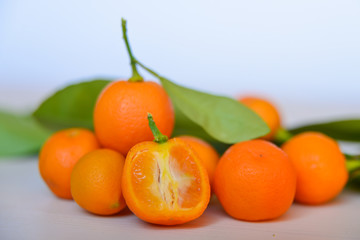 Calamondins on white cutting board