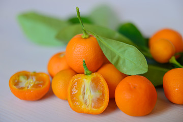 Calamondins on white cutting board