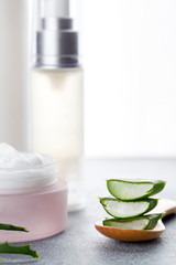Aloe vera sliced leaves and natural cream, lotion and tonic on white background