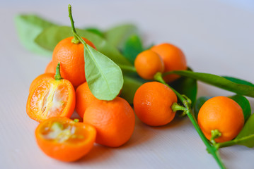 Calamondins on white cutting board