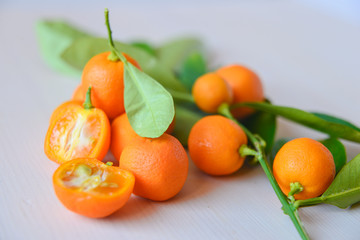 Calamondins on white cutting board