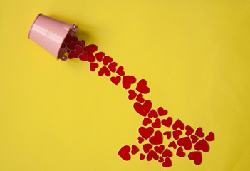 Metal bucket pouring red hearts