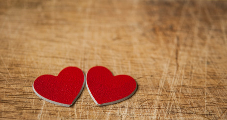 Fototapeta premium Valentine's Day card. Red hearts on wooden background. Greeting card concept. Top view