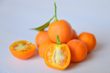 Calamondins on white cutting board