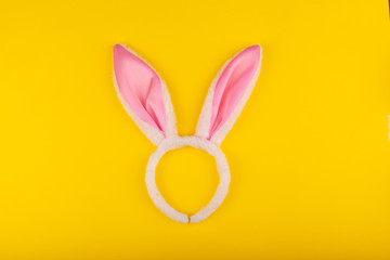 Rabbit ears to play with. Top view. Isolated on a yellow background. Preparing for Easter.