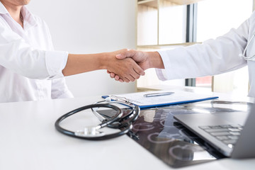Finishing of consulting, Doctor and patient shaking hands after a good and successful treatment in the hospital, healthcare and assistance concept