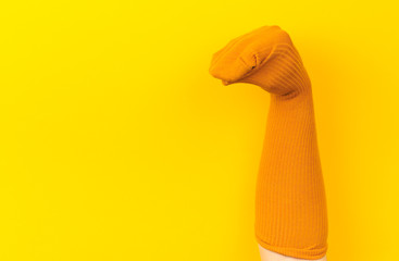 funny doll sock on yelow background, hand theater - Image