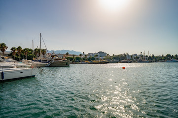 View of Kos harbor quay with ships on sunny day