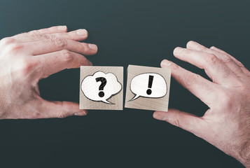 question and answer or communication concept with speech bubbles on wooden blocks