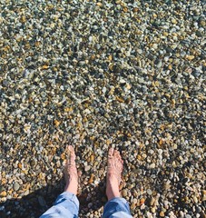 Transparent sea water with pebbles