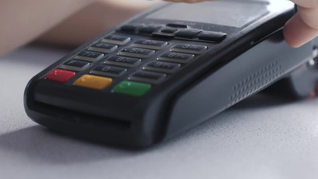 Payment by credit card, purchase lifestyle and sale of goods and services. Credit card in the store. girl pays on the card reader online shopping concept
