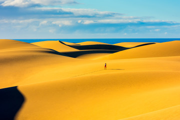 Unrecognizable person jogging in Maspalomas Sand Dunes Gran Canaria Spain