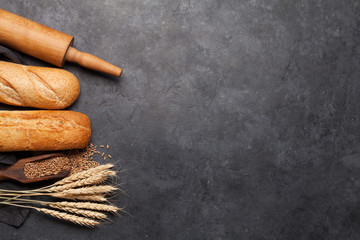 Various bread with wheat, flour and cooking utensils
