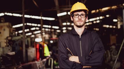 Portrait of an industrial worker standing with arms crossed feeling proud and confident looking for the new opportunity, new challenge, concept manufacturing industry, engineering worker profession.