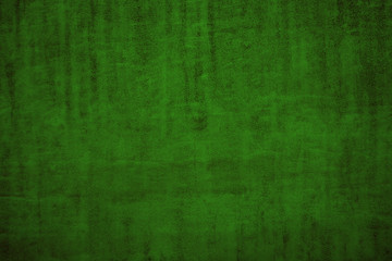 Texture of dark green surface with dimming. Festive Green Surface Background