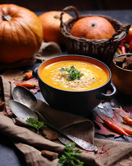 Concept of Russian cuisine. Pumpkin cream soup on a dark background. Background image, copy space