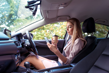 woman car interior, smartphone and cup coffee tea hand, having snack for lunch, parking city,...