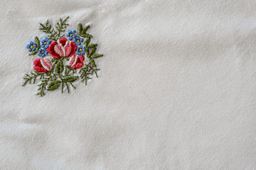 detail of an old tablecloth with flower embroidery
