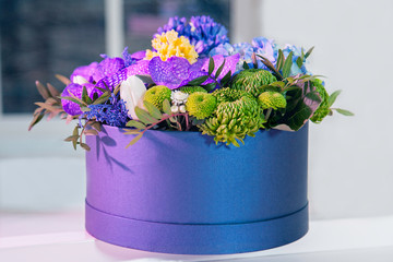 A bouquet of colorful flowers stands on a table