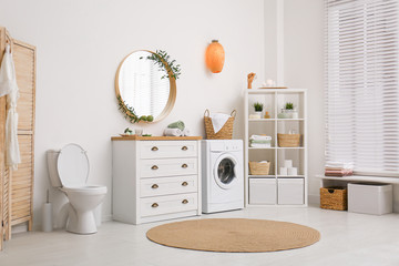 Interior of stylish bathroom with washing machine