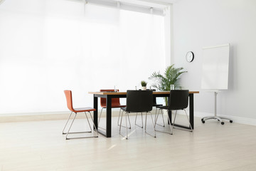Simple office interior with large table and chairs